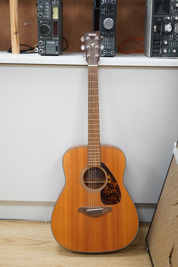 A Yamaha FG700MS acoustic guitar with a soft carry case